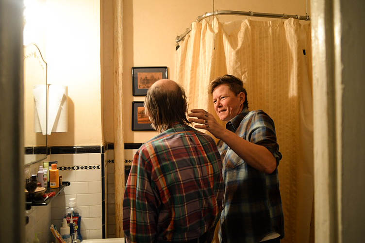 A single candle burning by a window